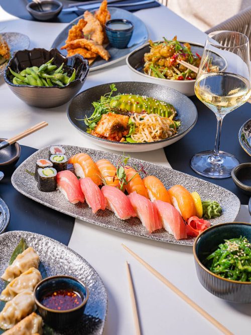 Table full of asian dishes on akakiko
