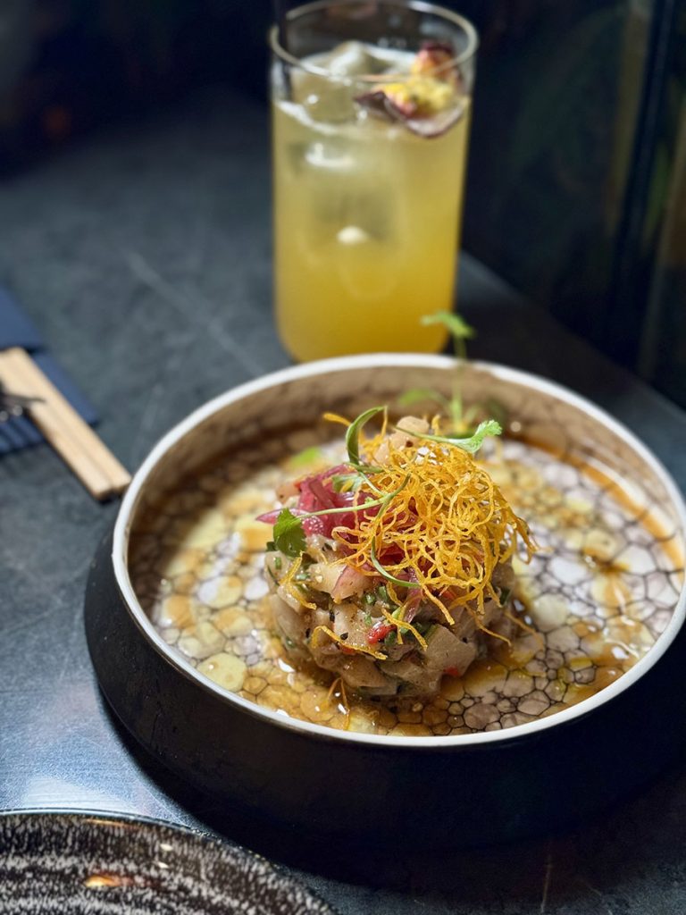 Asian inspired dish with side cocktail
