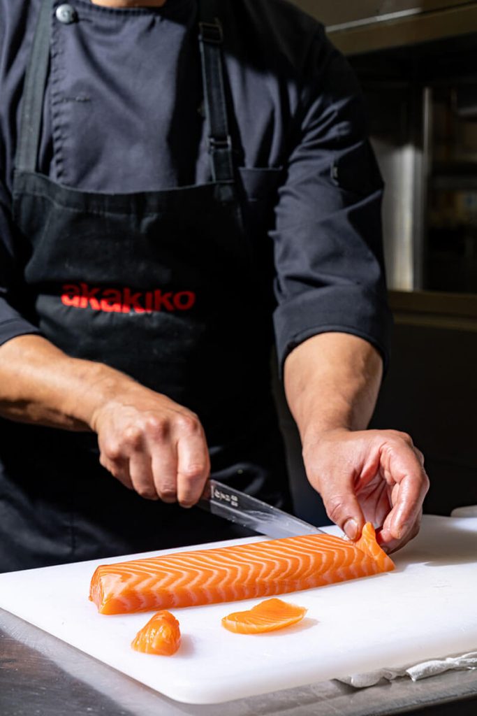 Chef cutting salmon at Akakiko