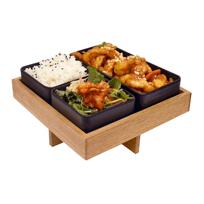 Asian food with side dishes on a wood platter