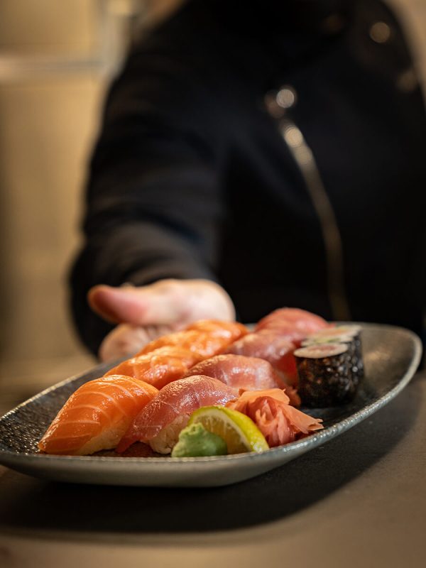 Chef serving a selection of sushi