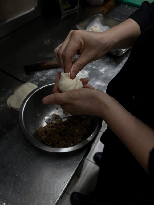 Chef preparing stuffing filling to dough