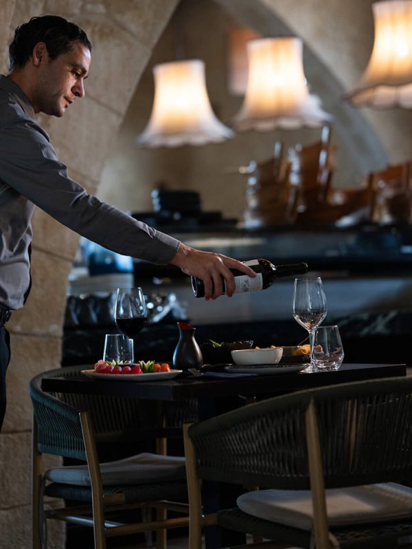 Waiter serving wine