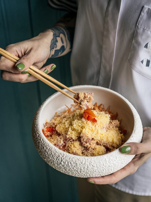 man eating asian inspired dish