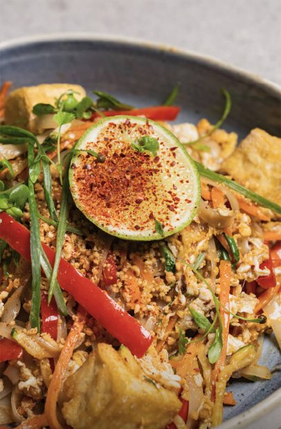 Noodles plated dish with tofu and greens